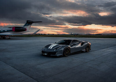 Completed Ferrari 488 bodykit during sunset featuring planes in the background