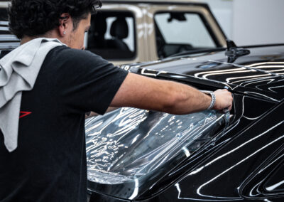 Paris Applying window tint to the rear window on the Audi RS6 Avant.