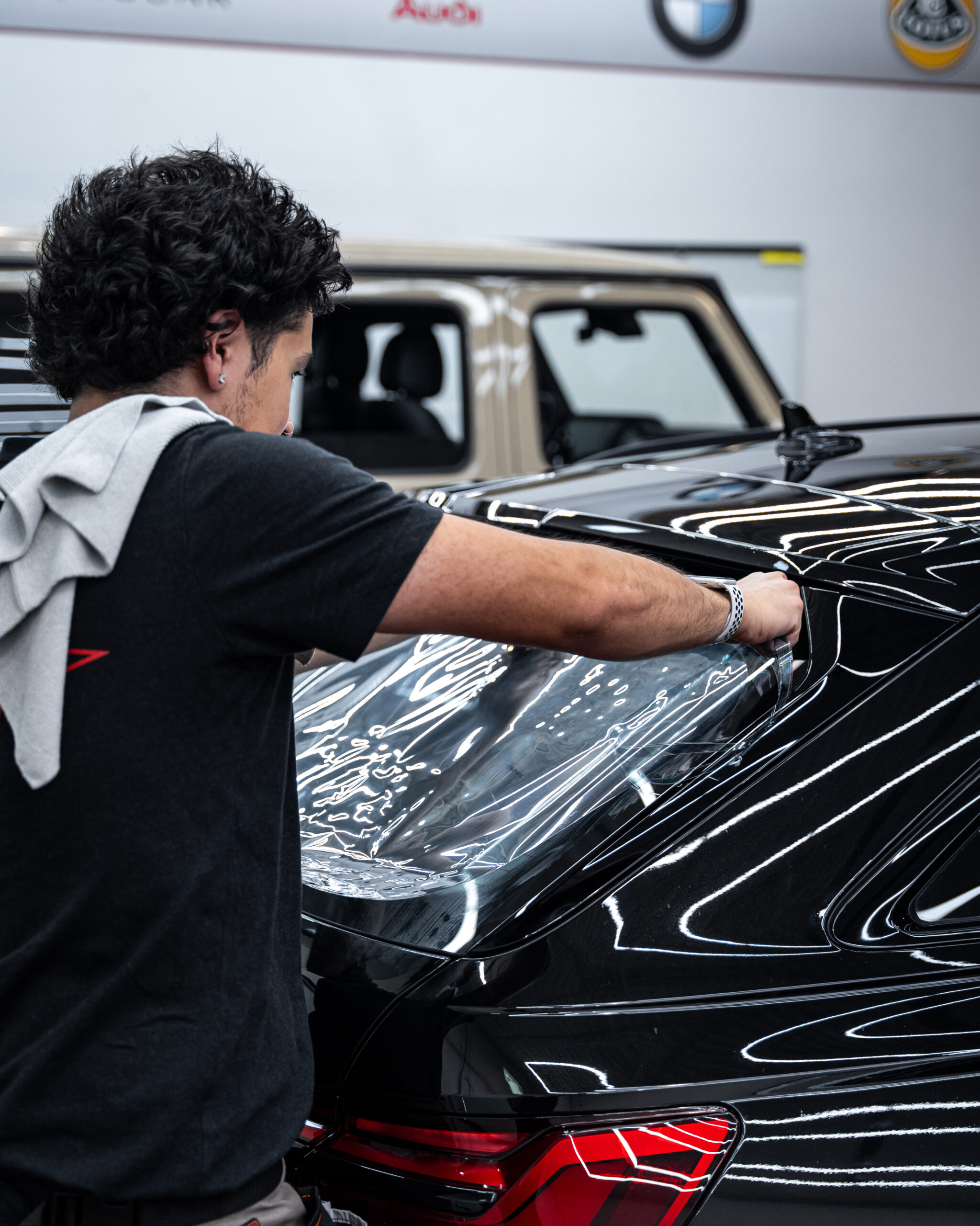 Paris Applying window tint to the rear window on the Audi RS6 Avant.