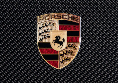 Closeup shot of the Porsche crest that sits on the carbon fiber hood of the GT4 RS