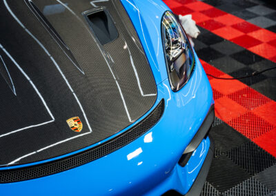 Closeup shot of the GT4 RS front bumper and carbon fiber hood ready for ceramic coating