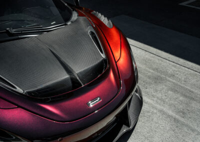 The carbon fiber Vorsteiner hood, fenders, and front lip enhancing the bodylines of the Mclaren 720s