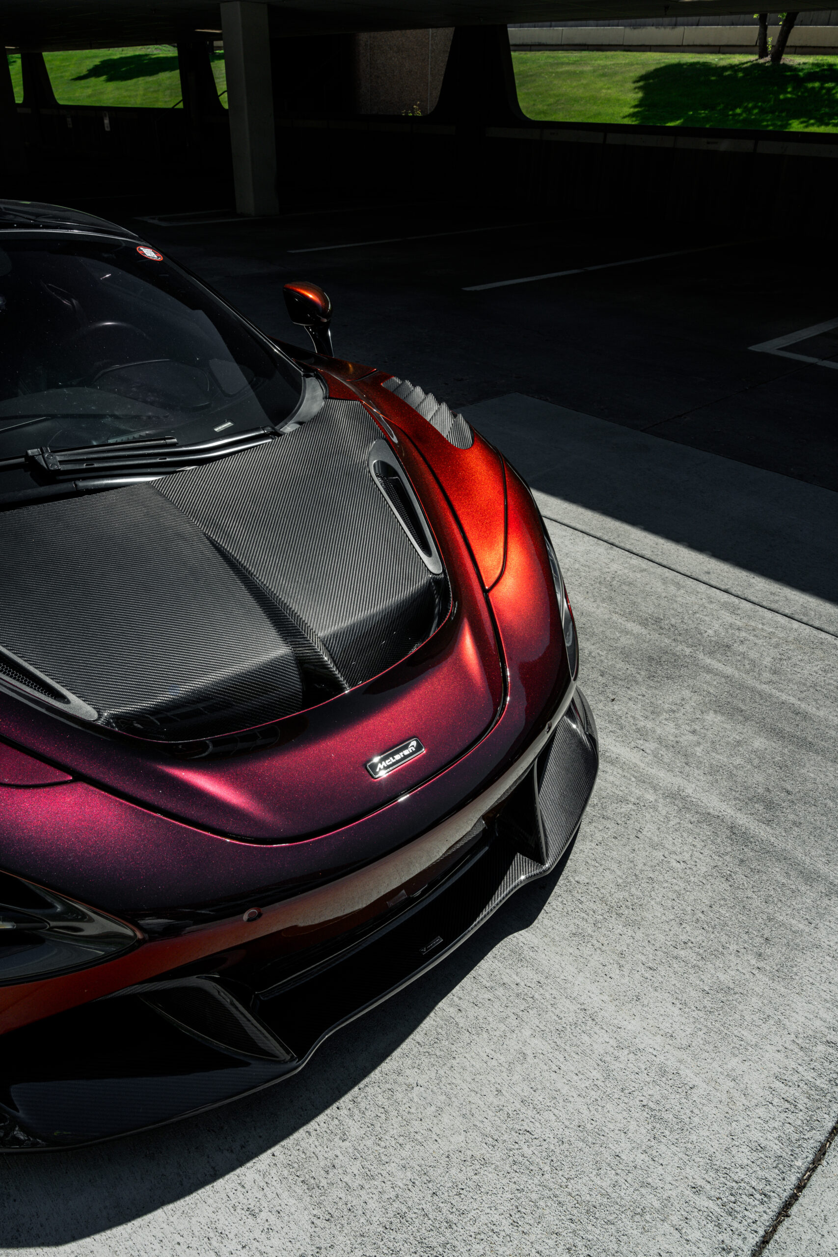 The carbon fiber Vorsteiner hood, fenders, and front lip enhancing the bodylines of the Mclaren 720s