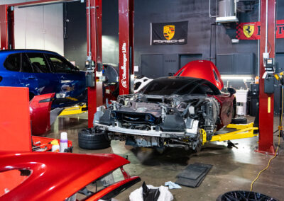 The Mclaren 720s disassembled, with bumpers and quarter panels resting on panel stands