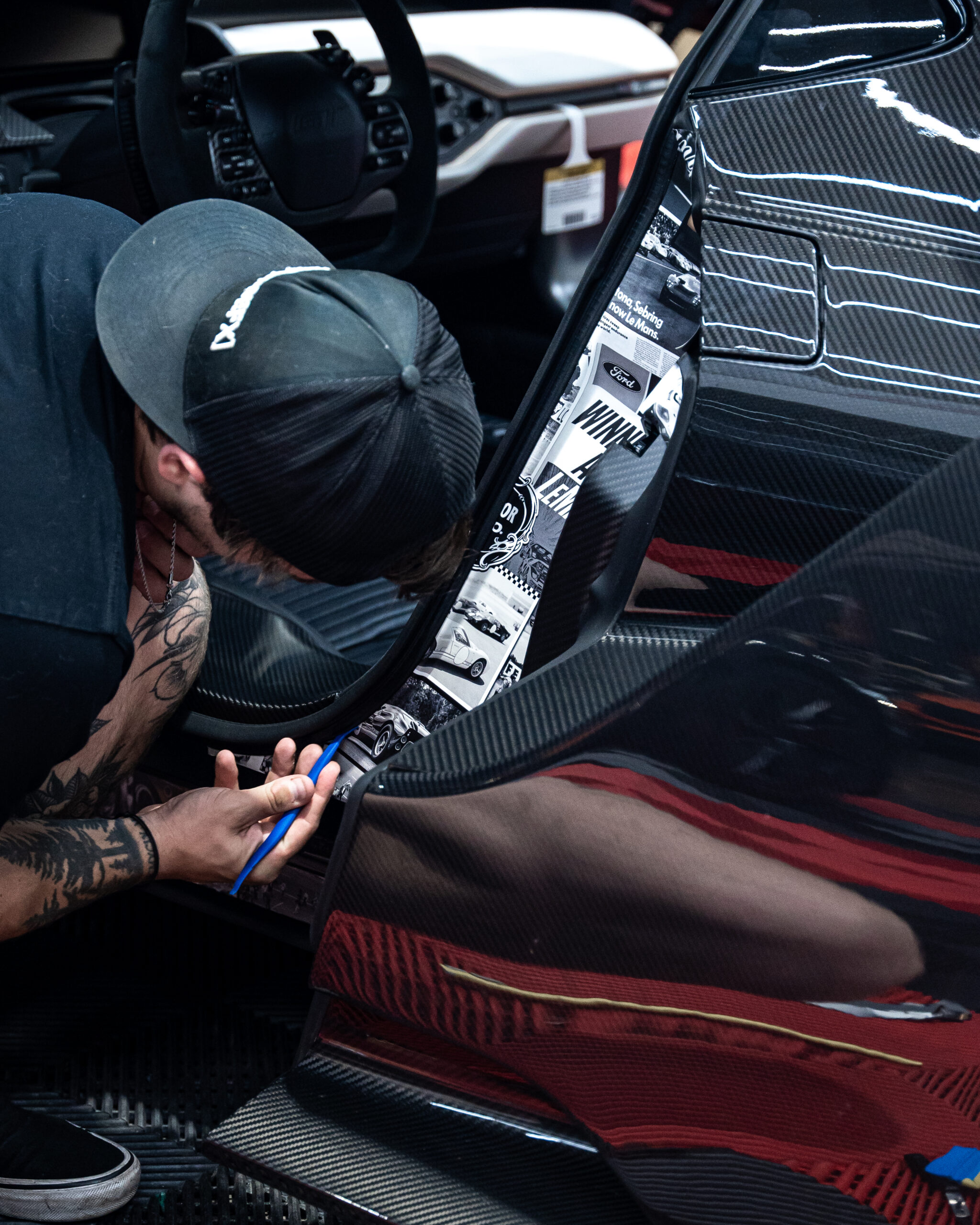 Jordan installing the Ford Racing tribute doorjambs on the Liquid Carbon Ford GT