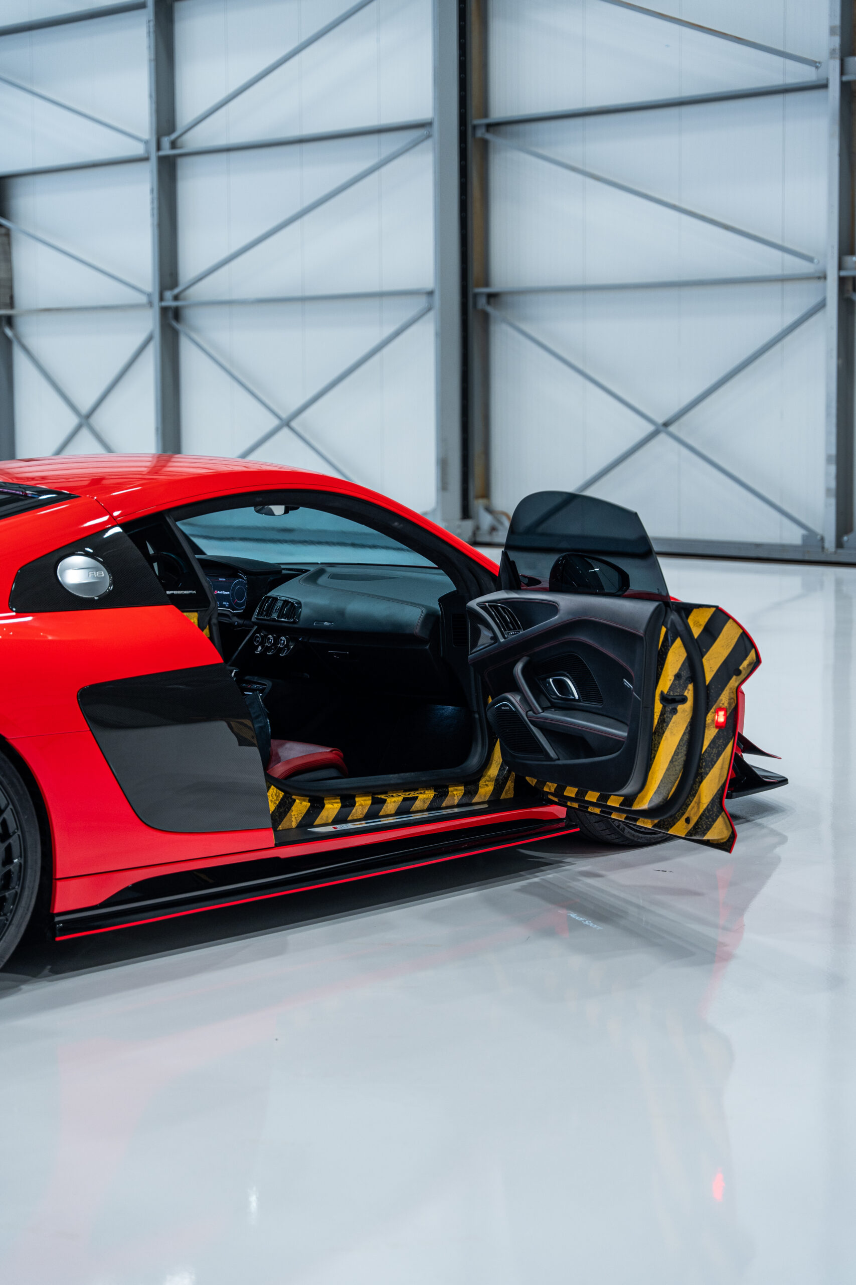 Jordan installing the Ford Racing tribute doorjambs on the Liquid Carbon Ford GT